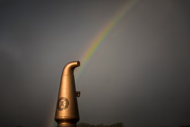 Rainbow above a copper whisky still outside Ardbeg Distillery on Islay captured by Clive Booth on the Canon EOS 5D Mark IV.